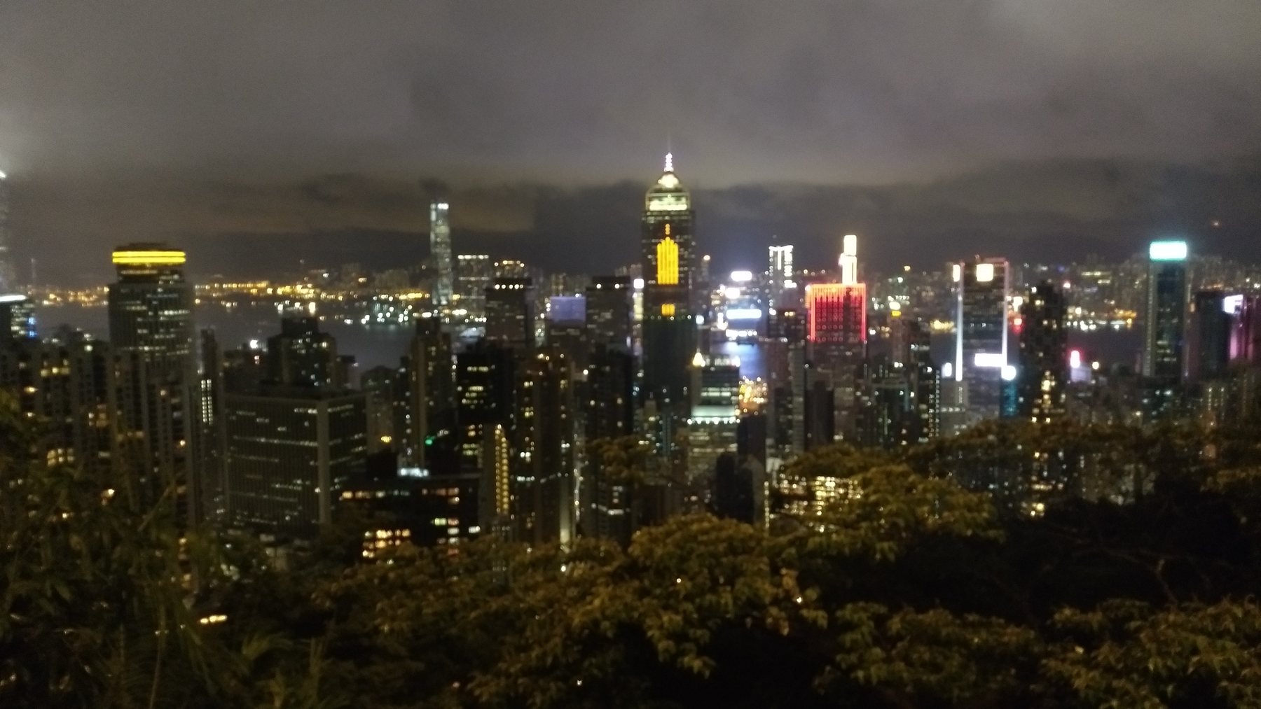 Hong Kong's illuminated skyline and harbour seen from The Peak at night