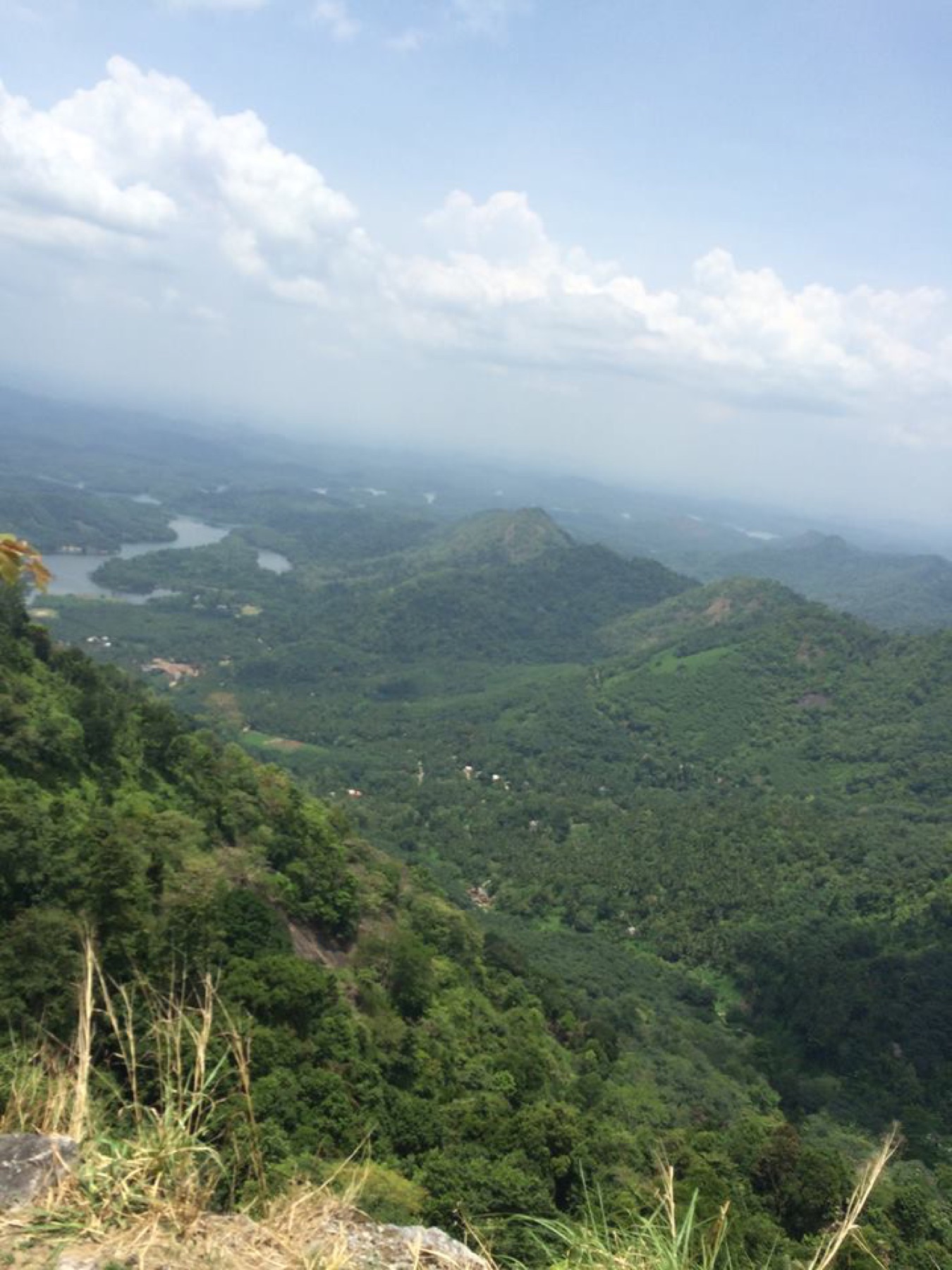 Layered forested hills and reservoir landscape at Kakkayam