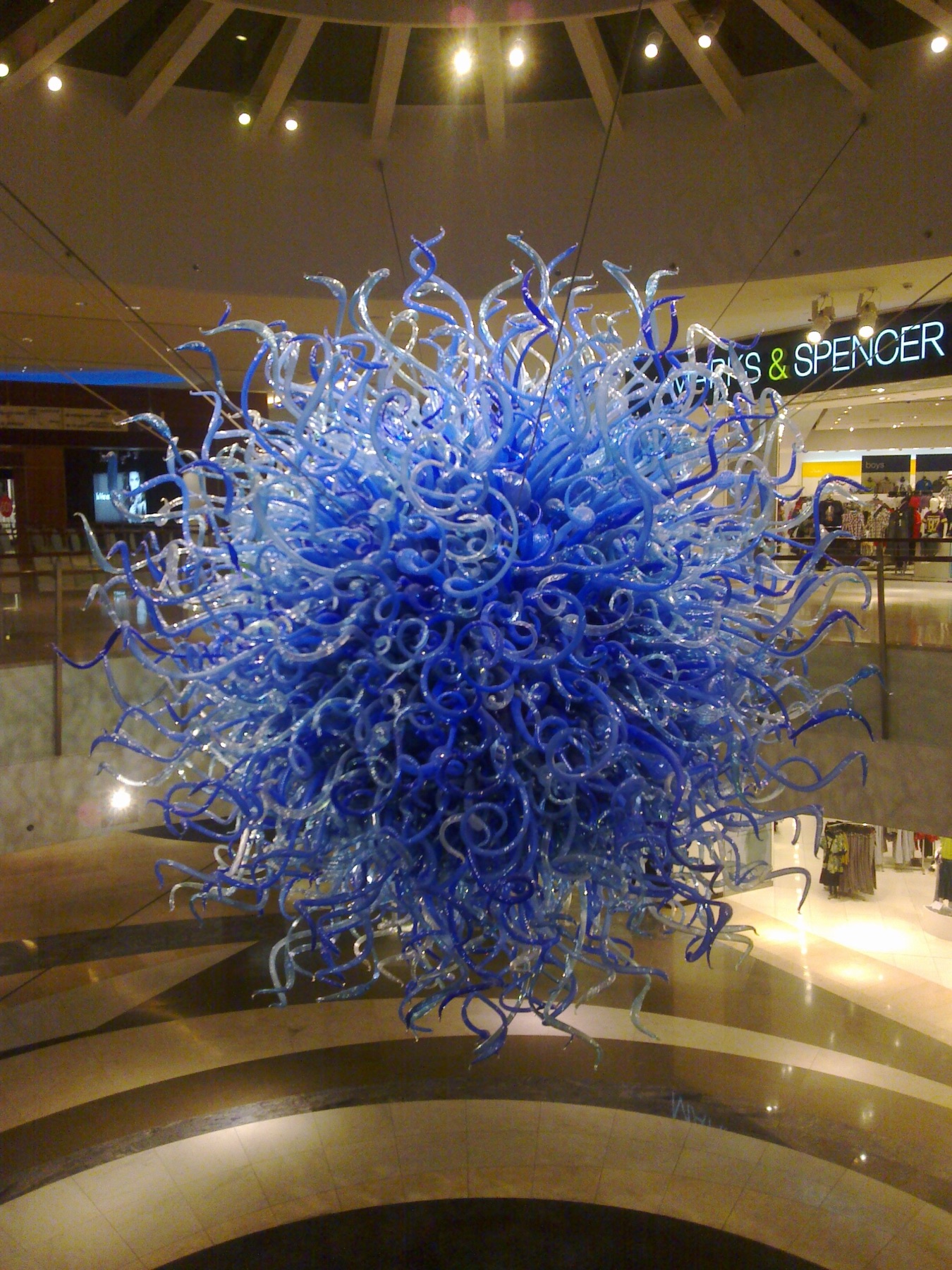 Blue glass sculpture suspended inside Kuwait's 360 Mall