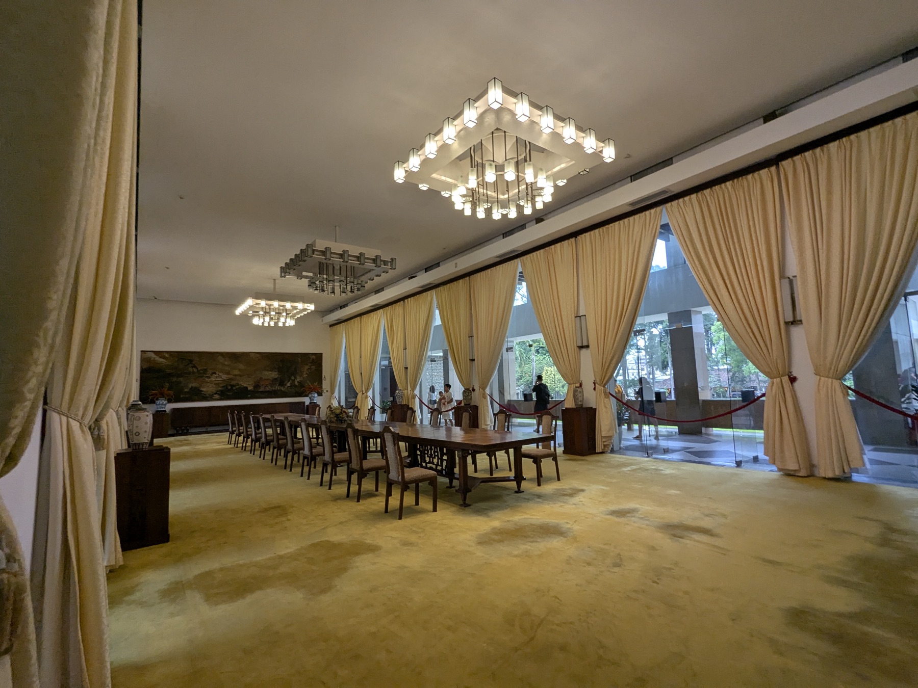 Geometric chandeliers and long reception tables inside Independence Palace